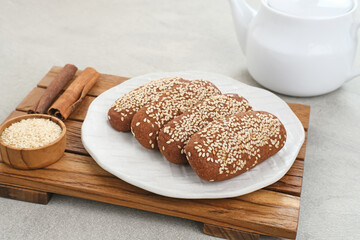 Roti Gambang or Ganjel Rel is Indonesian traditional snack with sesame seeds, flavoured with cinnamon and palm sugar. Served on white plate.
