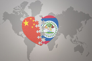puzzle heart with the national flag of china and belize on a world map background. Concept.