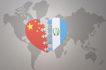 puzzle heart with the national flag of china and guatemala on a world map background. Concept.