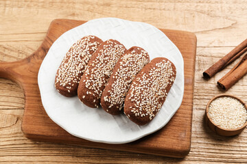 Roti Gambang or Ganjel Rel is Indonesian traditional snack with sesame seeds, flavoured with cinnamon and palm sugar. Served on white plate.
