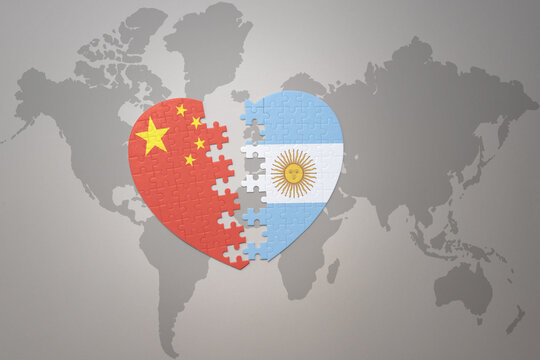 puzzle heart with the national flag of china and argentina on a world map background. Concept.