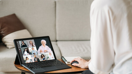 Web meeting. Group video chat. Internet communication. Business woman working from home using tablet cooperating online with team on screen in virtual office with free space.