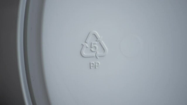 4k Closeup view of 5 pp recycling sign or label on white packaging spbd. Polypropylene has high melting point, so it's often chosen for containers that will hold hot liquid. It's gradually becoming
