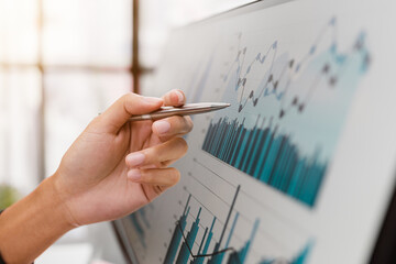 Close up hands of business analyzing financial report company and calculate profit with report summary.