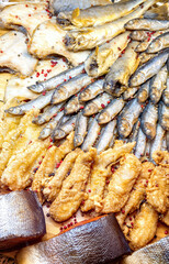 Various fried and smoked fish in the restaurant top view. Selective focus.