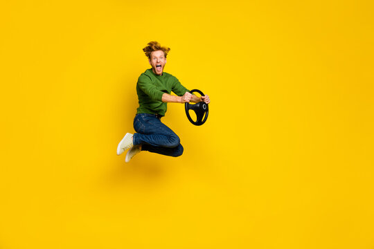 Full length photo of sweet cute man wear pullover fist rising auto empty space isolated yellow color background