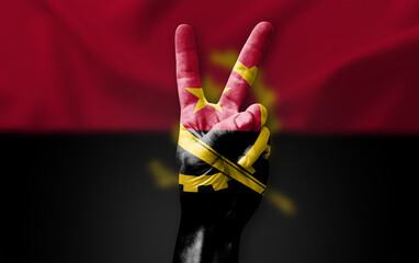 Hand making the V victory sign with flag of angola - obrazy, fototapety, plakaty