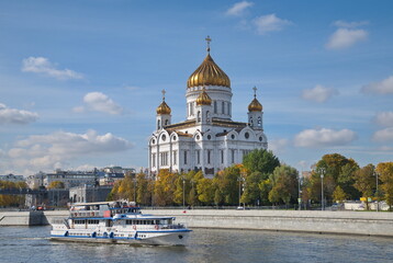Moscow, Russia - September 29: View of the Cathedral of Christ the Savior and a pleasure boat sailing along the Moscow River on an autumn sunny day