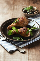 Spicy chicken drumsticks on wooden background. Copy space.	