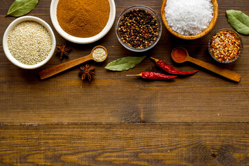 Powdered spices and herbs in bowls. Colorful cooking background
