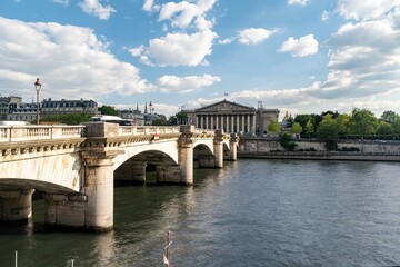 Fototapeta premium National assembly facade in Paris, France under the blue sky. Assemblee Nationale with French and EU flags
