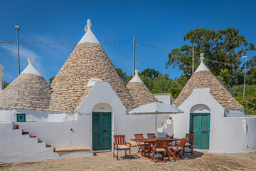 A trullo is a traditional Apulian dry stone hut with a conical roof.