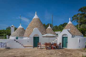 A trullo is a traditional Apulian dry stone hut with a conical roof.