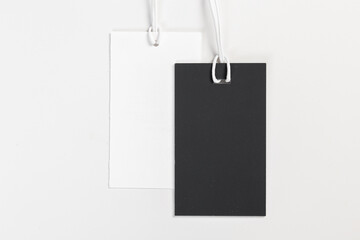 a pair of fashionable blank labels for clothes on a gray background