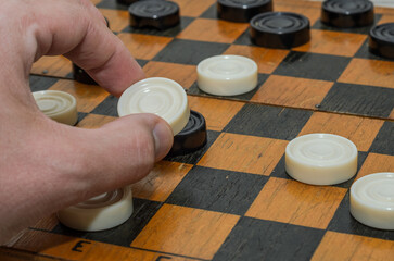 People play checkers on a chessboard