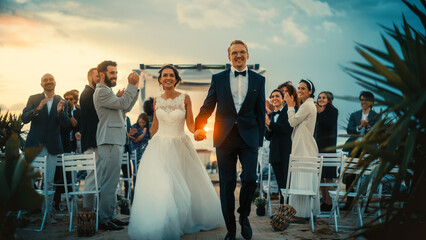 Beautiful Bride and Groom Celebrate Wedding Outdoors on a Beach Near the Ocean at Sunset. Perfect...