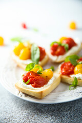 Tomato crostini with cream cheese and fresh basil