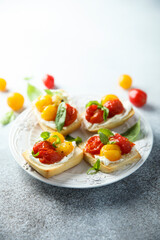 Tomato crostini with cream cheese and fresh basil