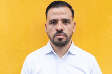 Portrait of man standing against wall