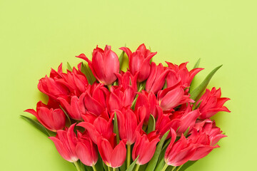 Bunch of red tulips on green background. Mother's day, Valentines Day, Birthday celebration concept