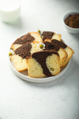 Fototapeta na wymiar Homemade vanilla chocolate marbled cake on a plate