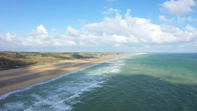 The long sandy beach of Omaha beach in Europe, France, Normandy, towards Carentan, in spring, on a sunny day.