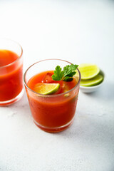 Homemade tomato cocktail with fresh lime