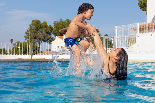 Mother Having Fun With Her Son By Throwing Him In The Pool