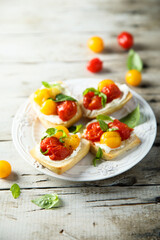 Tomato crostini with cream cheese and fresh basil