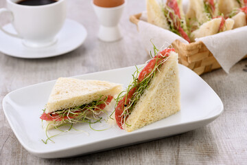 Wheat toast sandwich with cream cheese with microgreen alfalfa sprouts and salami. Healthy and fresh food.