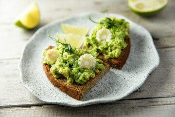 Homemade avocado toast with corn and lime