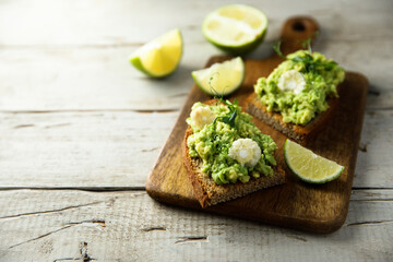Homemade avocado toast with corn and lime