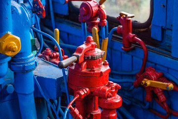 Red and blue retro control panel of an old vintage steam train cabin close up.