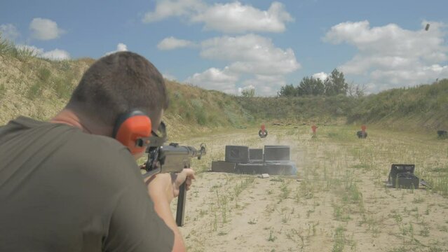 a man shoots TVs at a shooting range