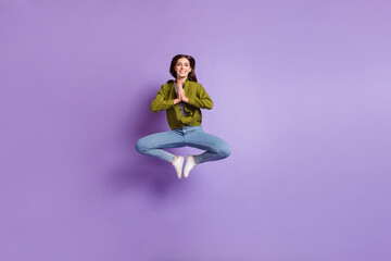 Full size picture of good mood lovely lady jumping up in yoga pose practice zen isolated on purple color background