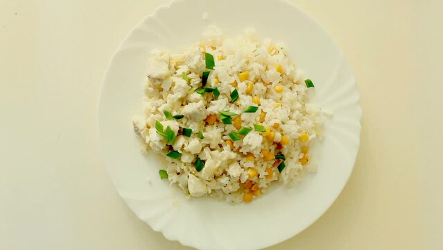 dish with rice, green onions, corn and fish 