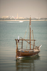 Doha,Qatar- April 24,2022 Traditional boats called Dhows are anchored in the port near the Museum of Islamic Art Park.
