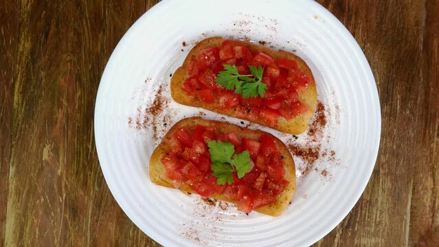 Tomato sandwich or italian bruschetta with parsley