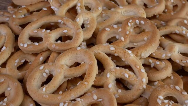 Pile of pretzels sprinkled with sesame rotate.