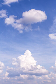 Beautiful blue sky with white fluffy cumulus clouds background texture © Viktor Iden