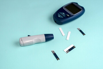 Glucose meter for diabetes tester using as Medicine, glycemia, healthcare and medical concept. Blue background.