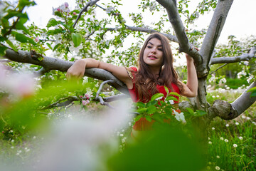 Young woman in apple orchard in indian costume