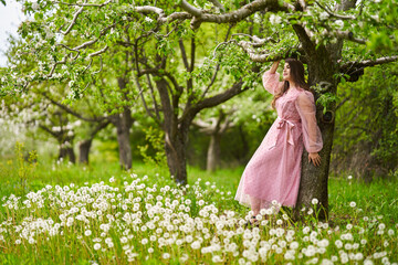 Young woman in apple orchard