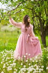 Fototapeta na wymiar Young woman in apple orchard