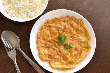 Thai omelette on a white plate.  Flat lay top view photo.  Food from above. 