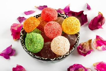 Close up view of multicolored sugary jelly candies on a bowl.