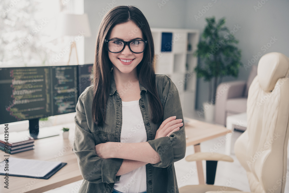 Aufkleber portrait of attractive cheerful content girl expert developing web project folded arms at workplace 