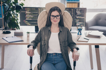 Portrait of attractive cheerful skilled girl sitting in chair developing web tech startup outsource...