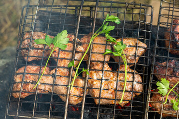 Grill grate with beef meat on a brazier with flaming charcoal