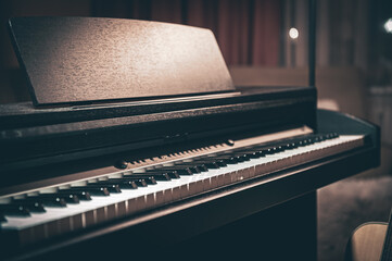 Close-up, electronic piano in a dark room.